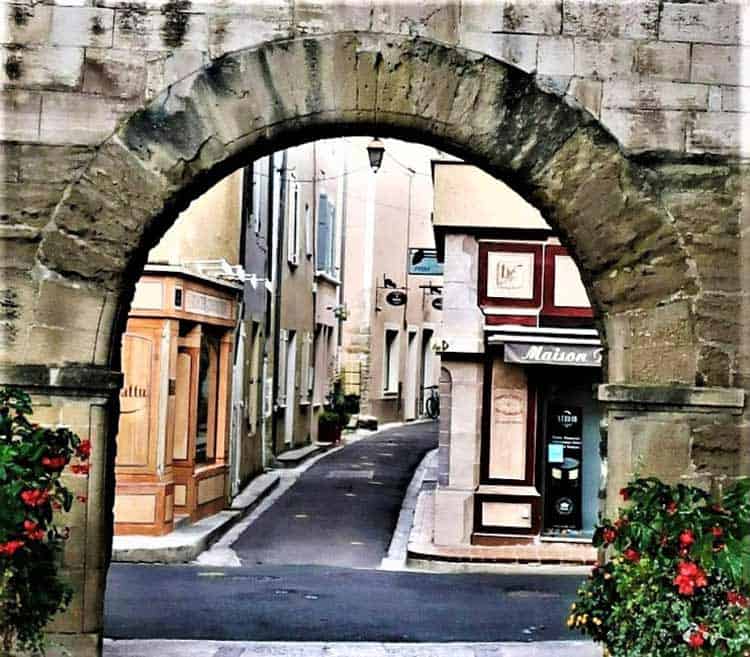 A street in Pernes Les Fontaines, Provence seen through a medieval city gate. Photo by Victor Block
