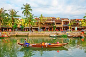 Riverside tranquility in Hoi An, Vietnam, where colorful boats drift along ancient waterways. Photo by Samart Boonyang via Canva