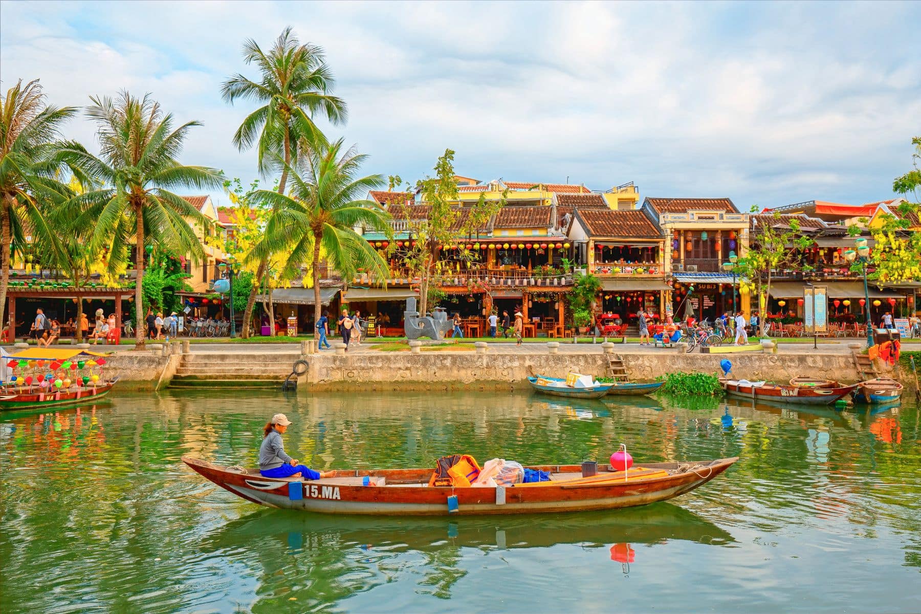 Riverside tranquility in Hoi An, Vietnam, where colorful boats drift along ancient waterways. Photo by Samart Boonyang via Canva