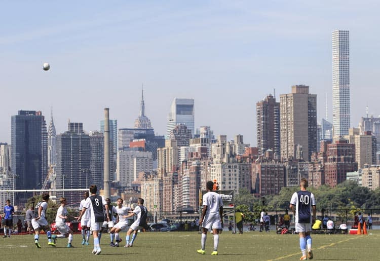 New York City’s skyline provides a backdrop for a soccer game on Randall’s Island, New York City. Photo by PicturemakersLLC/Dreamstime