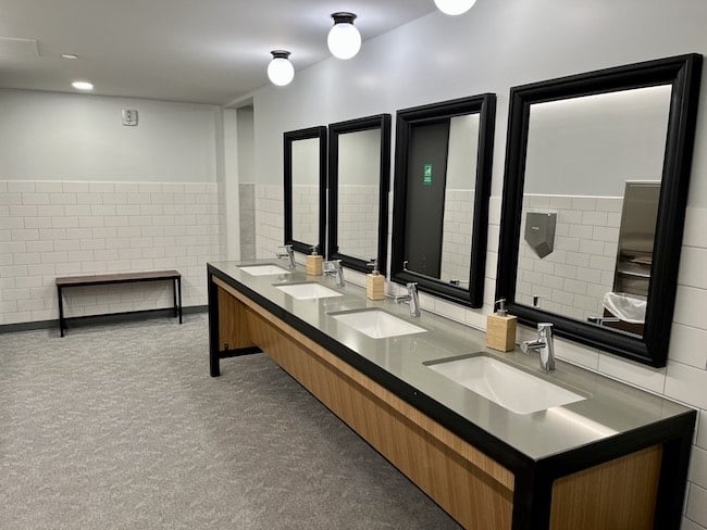 Shared bathroom includes showers and changing spaces.