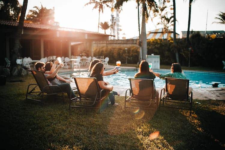Friends having drinks by the pool. Photo by Helena Lopes