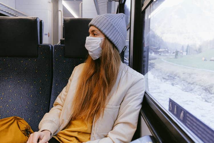 Woman in mask on a train. Photo by Anna Shvets