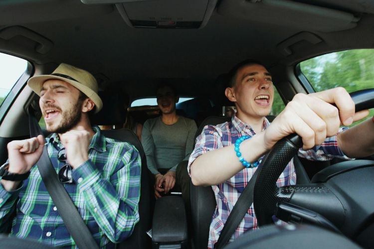2 men singing in a car