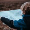 Child with map. Photo by Annie Spratt