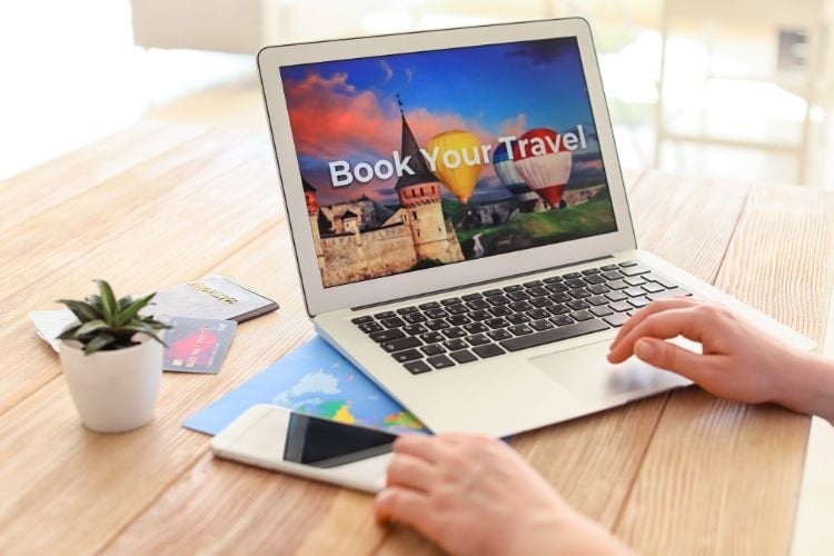 person booking travel on a laptop