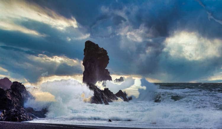 Iceland Waves crashing against black volcanic monoliths
