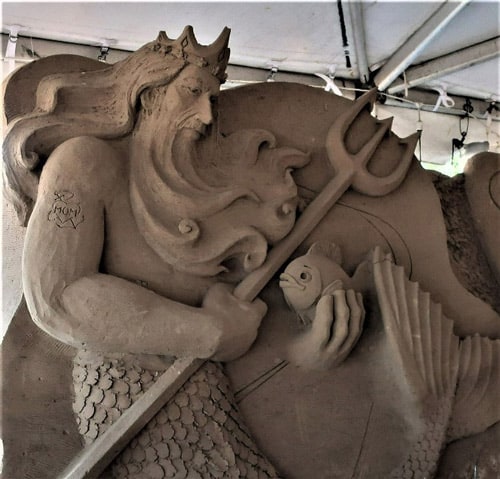 A gigantic Neptune watches over his flock of sand sculptures at Sandcastle Village in South Padre Island, Texas. Photo by Victor Block