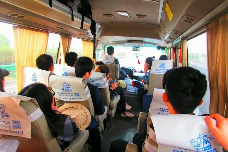 Chinese tourists travel by bus to their next attraction. Photo by Donovan Cosby