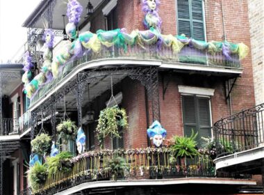 Wrap-around porches, wrought-iron decor and Mardi Gras decorations are often found gracing New Orleans’s architecture. Photo by Victor Block