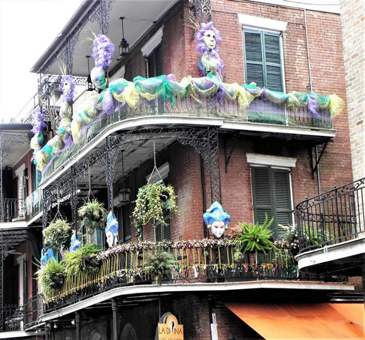Wrap-around porches, wrought-iron decor and Mardi Gras decorations are often found gracing New Orleans’s architecture. Photo by Victor Block
