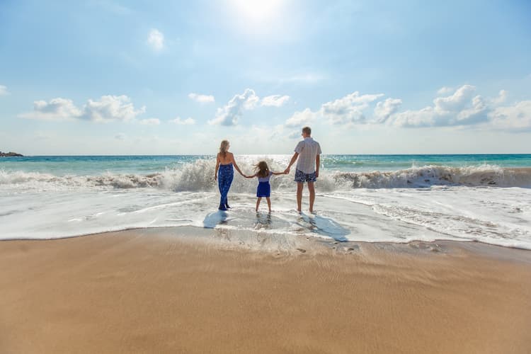 Family on a beach. Photo by Natalya Zaritskaya