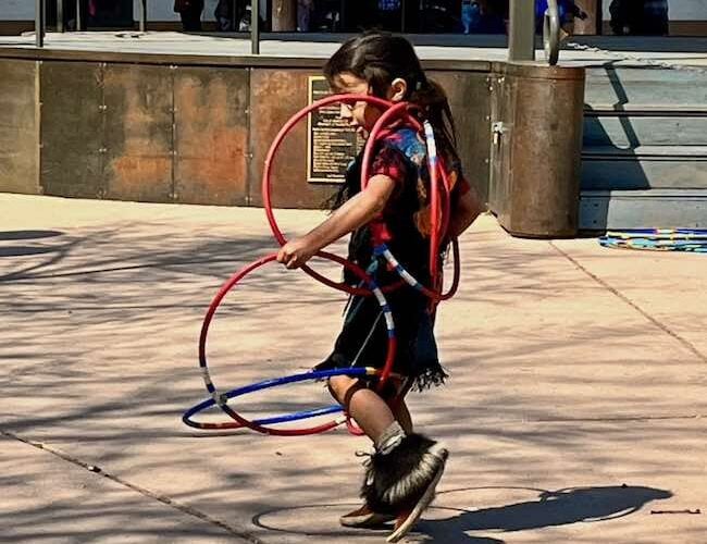 A live Indian boy doing the traditional hoop dance. He's performing on the plaza with The Lightning Boy Foundation that seeks to nurture culture and artistic expression through dance. Photo by Claudia Carbone.