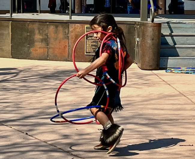 A live Indian boy doing the traditional hoop dance. He's performing on the plaza with The Lightning Boy Foundation that seeks to nurture culture and artistic expression through dance. Photo by Claudia Carbone.