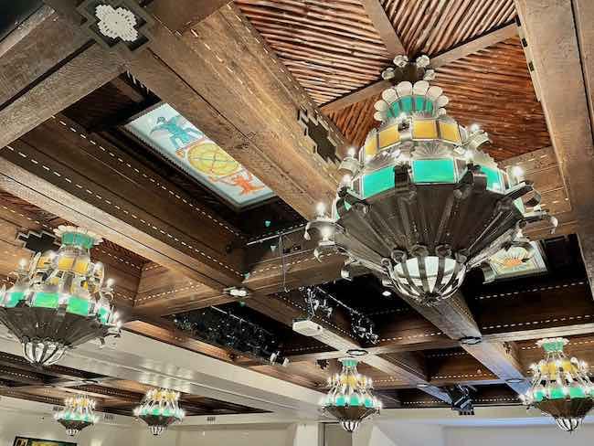 These gorgeous stained glass and tin chandeliers in the ballroom of La Fonda are original. Photo by Claudia Carbone