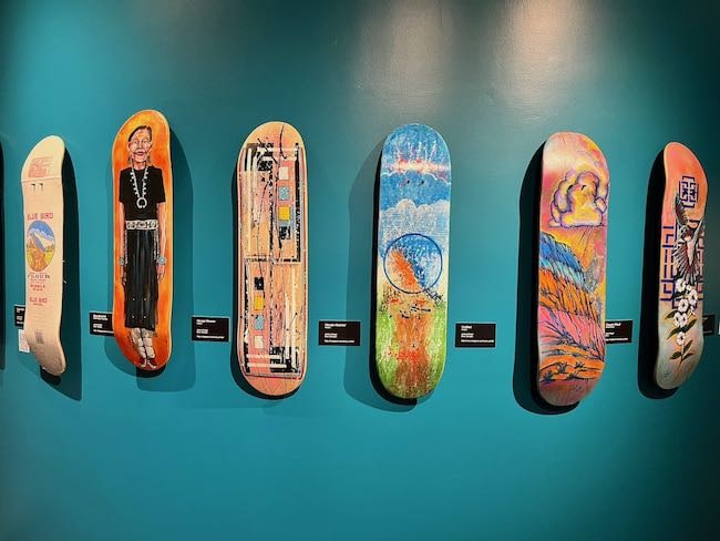 A display of skateboards painted by contemporary artists. Photo by Claudia Carbone