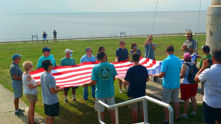 Kathy Hosek (far Left) and 14 volunteers prepare to raise flag over Fort Sumter