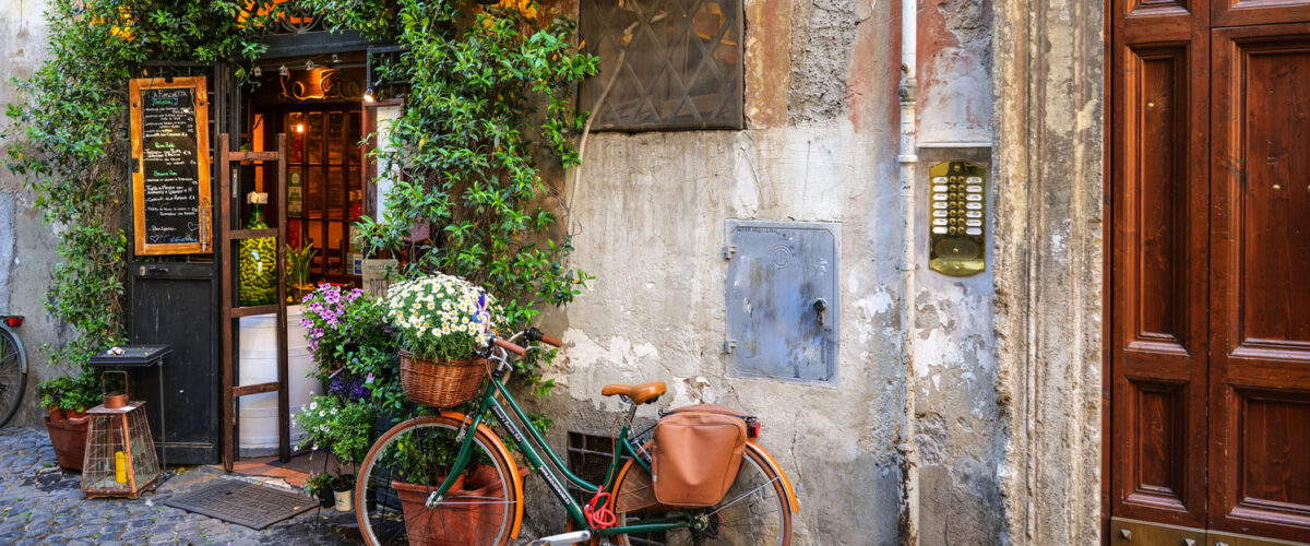 Bike learning against a wall in a scenic photo of Rome