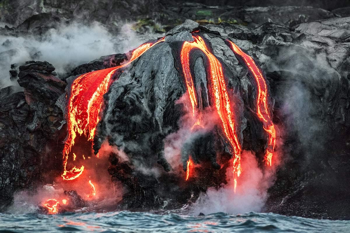 Kilauea volcano lava flows into the ocean. Photograph by Hawai’i VCB
