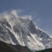 The wind blowing snow over the peaks in Sagarmatha National Park, Nepal.