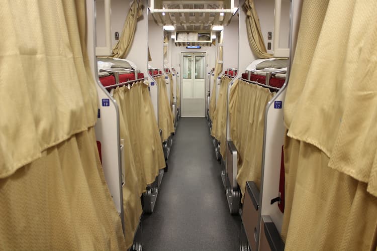 Train aisle with closed curtains. Photo by Thomas Später