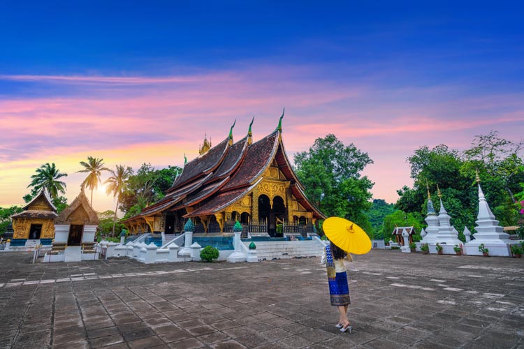 Asian woman wearing laos traditional at Wat Xieng Thong (Golden City Temple) in Luang Prabang, Laos.