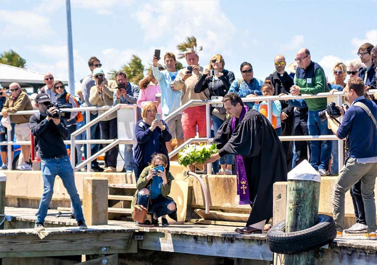 People gather in Panama City, Florida to pray for the safety of local fishermen. Photo by Doug Dobos/Destination Panama City