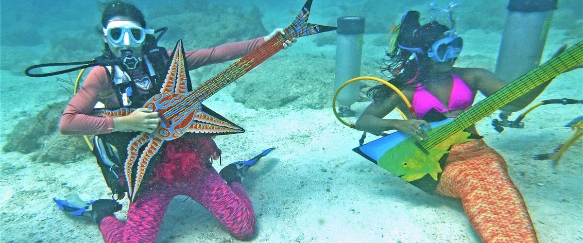Mermaids “playing” instruments at the Underwater Music Festival in the Florida Keys. Photo by Mike Papish