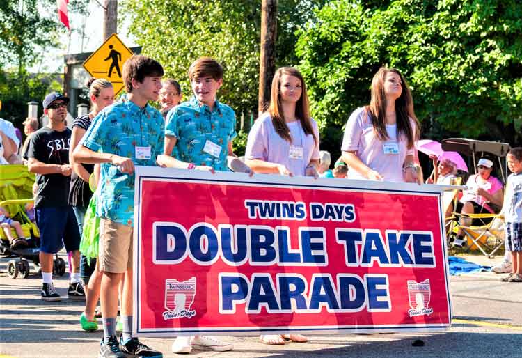 Twins, and twins, march in the Double Take Parade during Twin Day in Twinsburg, Ohio. Photo by Kenneth Sponser/Dreamstime