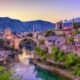The Neretva river winding through the old UNESCO listed, Mostar bridge in Bosnia and Herzegovina, iStock