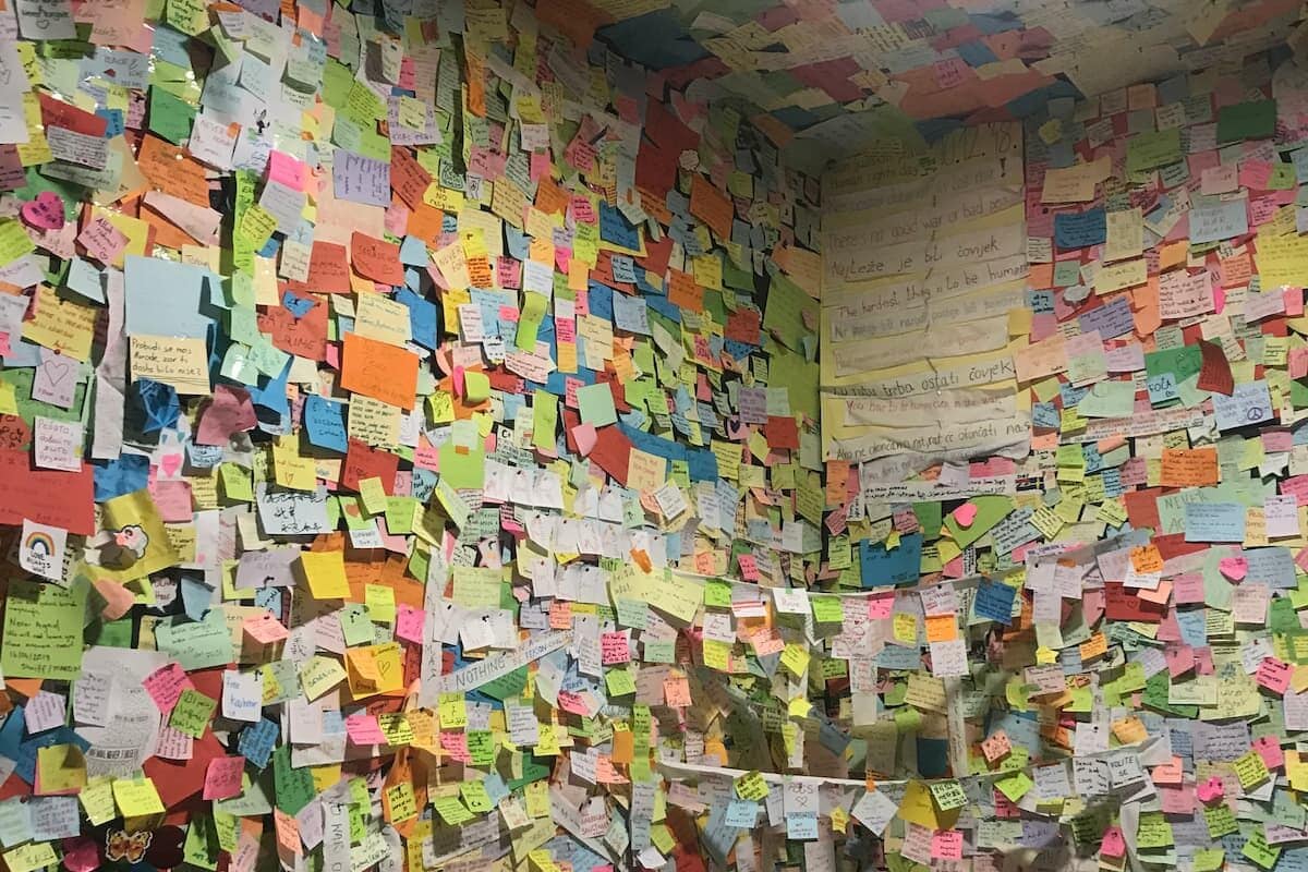 The final room of the War Crimes Museum with post-its. Photo by Ted Bechtold
