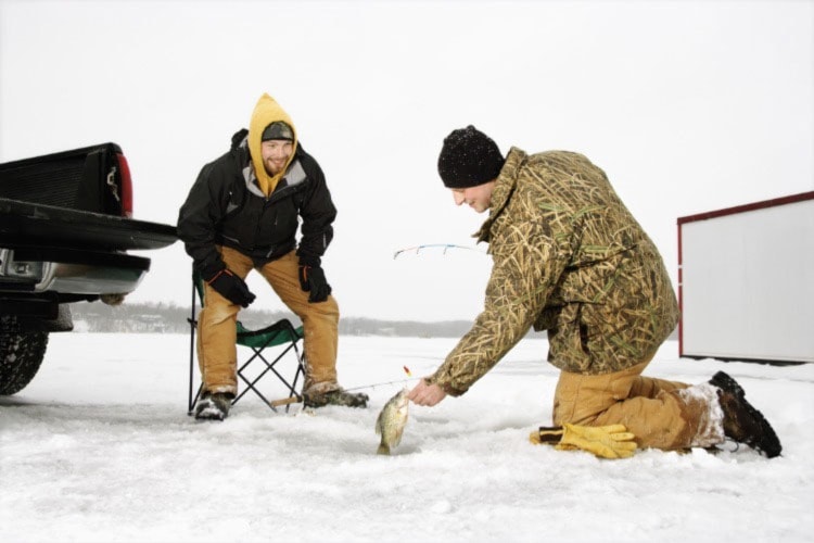 Winter cold doesn’t deter some dedicated fishermen. Photo by Lofoto/Dreamstime