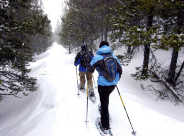 A couple enjoys snowshoeing in the Colorado Mountains. Photo by Gelynfjell/Dreamstime