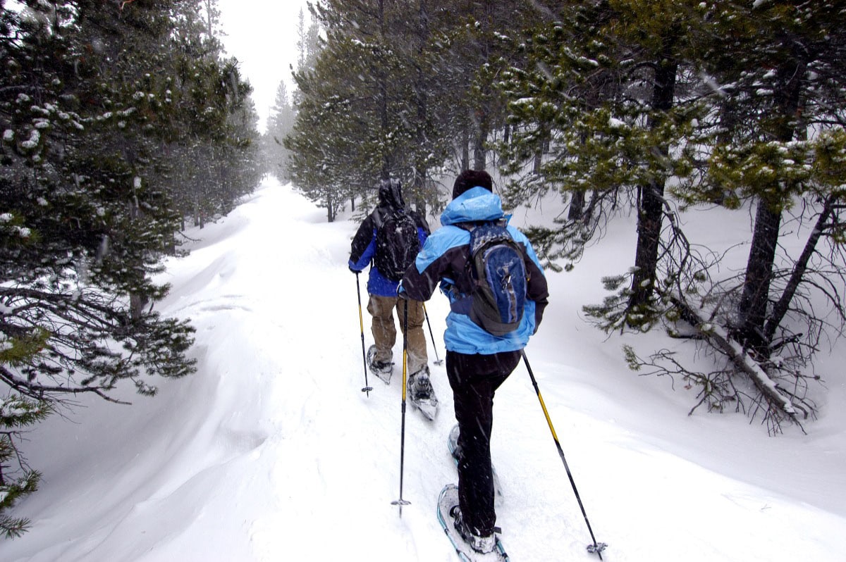 A couple enjoys snowshoeing in the Colorado Mountains. Photo by Gelynfjell/Dreamstime