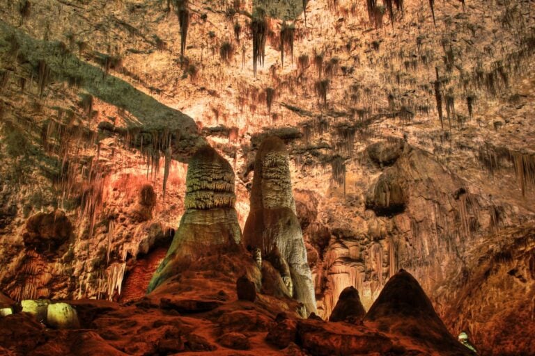 Massive stalactites and stalagmites fill the chambers at Carlsbad Caverns, formed over millions of years by mineral-rich water. Photo by elan7t50 via iStock