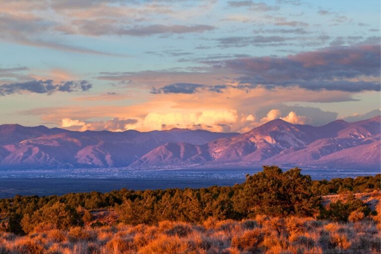 Taos Valley, New Mexico at sunset with a thunderstorm developing on the east side of the Sangre de Cristo Mountains. Photo by MonaMakela via iStock
