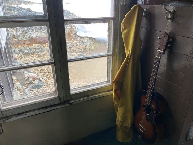 Rain slicker and old guitar at Wordie House