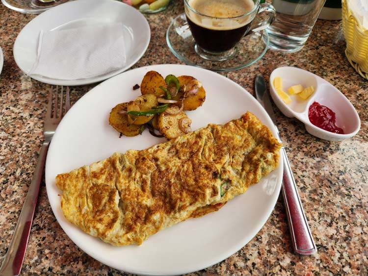 Veggie omelet from the Green Palm Boutique Hotel's vegetarian cafe. Breakfast is included with hotel stays. However, dinners are extra and no lunch is served. 
