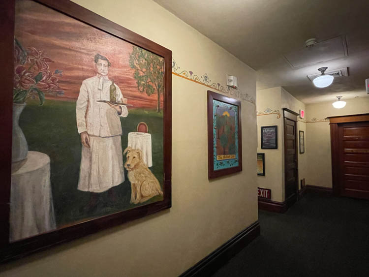 Paintings and photos line the walls at Hotel Oregon