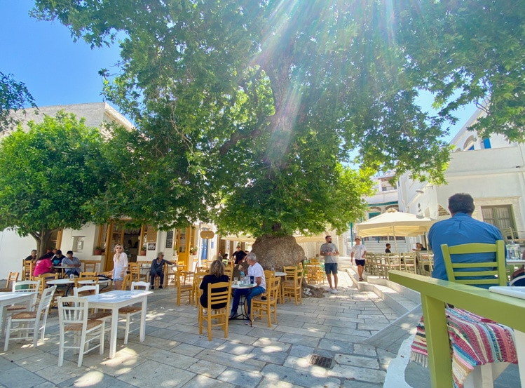 Families and friends gather at cafés flanking a square in Pyrgos, Tinos