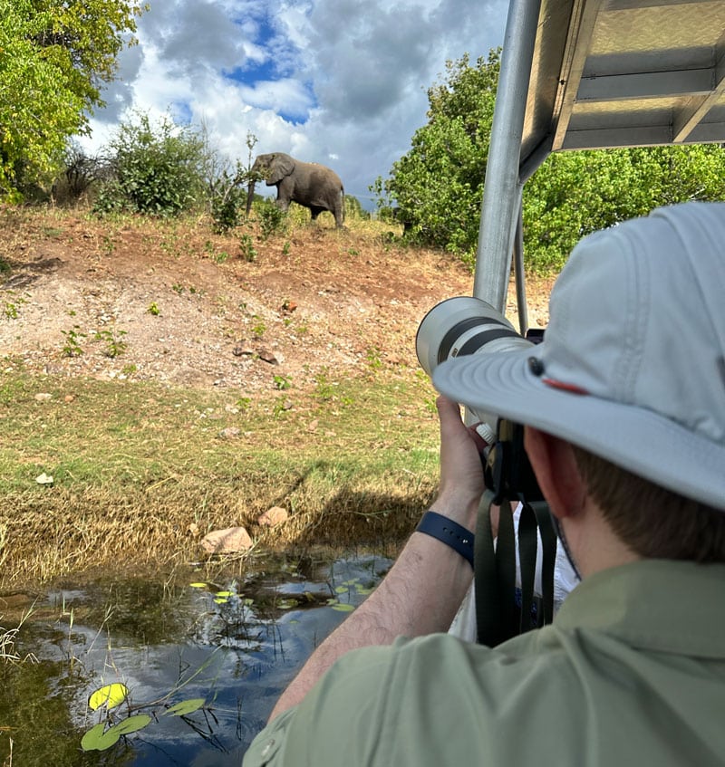 Benjamin photographs an elephant during a safari. Photo by Janna Graber