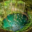 Inside a Yucatan cenote—one of thousands of underground swimming holes hidden beneath the jungle. Photo by Alex Blackbird from Getty Images via Canva