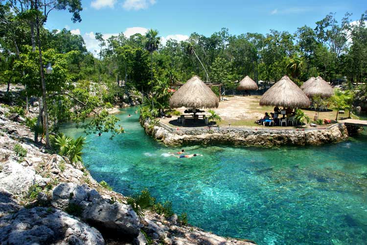 Cenote with crystal clear blue waters near Tulum, Mexico.