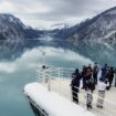 Mesmerized travelers soak in Alaska's dramatic glacier views from the ship's bow. Photo by Robert Linder, Unsplash