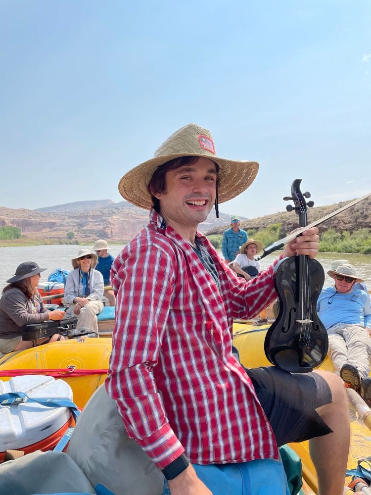Francisco Fullana and his carbon fiber violin during a Musical Raft Trip during the Moab Music Festival