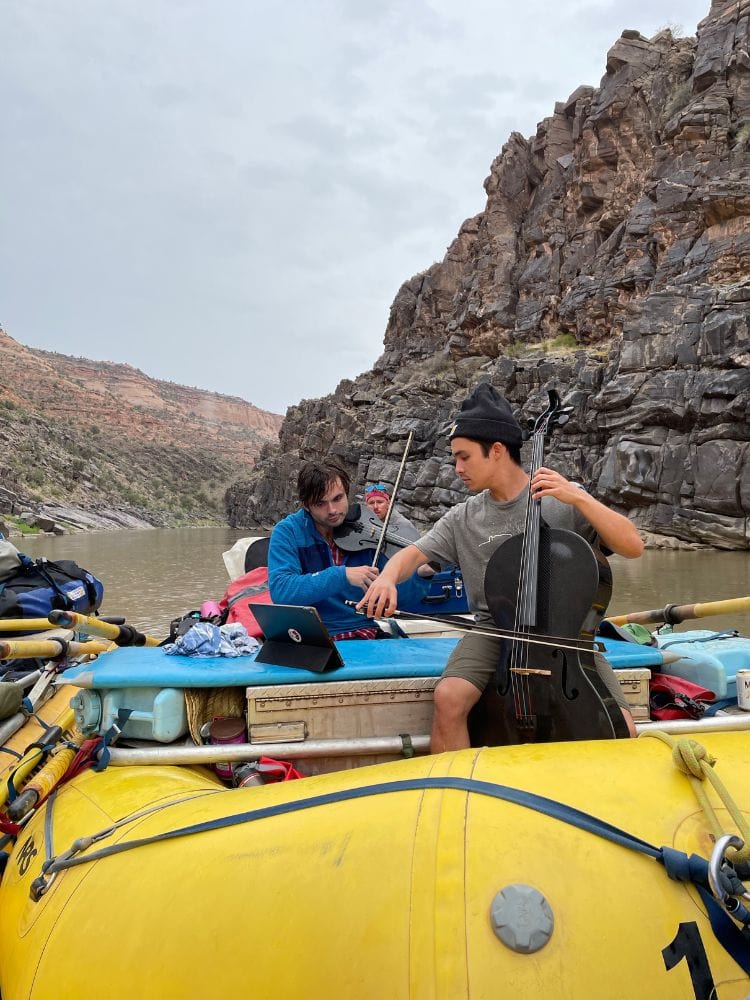 Jay Campbell and Francisco Fullana perform on river rafts as part of the Moab Music Festival’s Westwater Canyon trip