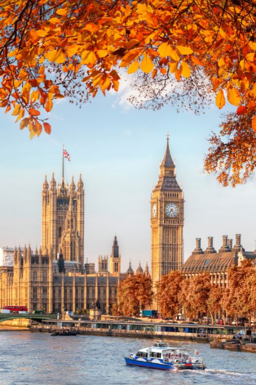 Big Ben with autumn leaves in London, England, UK. An amazing Fall destination in Europe. By Tomas Marek