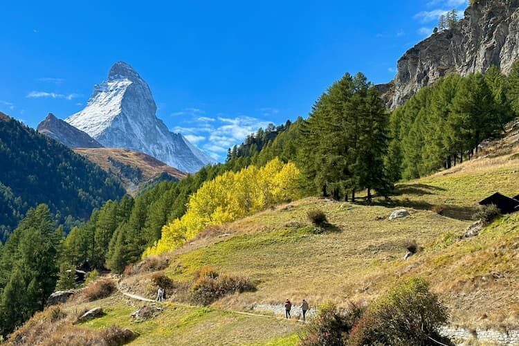 Hikers make their way along a path beneath the distinctive silhouette of the Matterhorn. Photo by Amy Laughinghouse.
