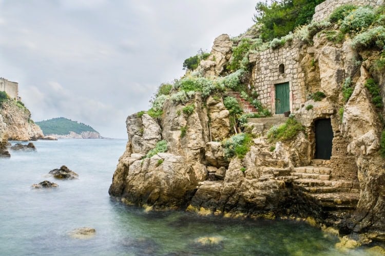 Doorways of houses built into the cliff face in Kolorina Bay in Dubrovnik, Croatia. Photo by Barbara Vallance / iStock