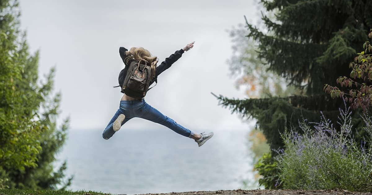 Woman jumping with backpack. Photo by Pexels, Pixabay